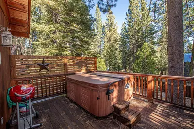 a hot tub on the deck of a cabin at Sherman By Hauserman Rentals in Tahoma