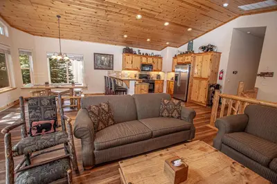 a living room with a couch and a kitchen at Sherman By Hauserman Rentals in Tahoma