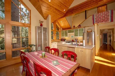 a kitchen with a table and chairs in a house at Snowglobe By Hauserman Rentals in Tahoe City