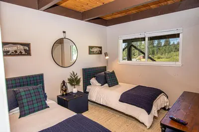 a bedroom with two beds and a mirror and a table at St Francis #53 By Hauserman Rentals in Tahoe City