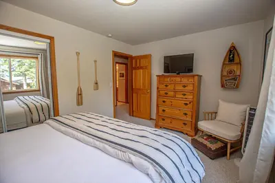 a bedroom with a bed and a tv and a dresser at Eagle Pines By Hauserman Rentals in Tahoe City