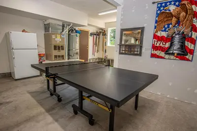 a ping pong table in a room with a refrigerator at Eagle Pines By Hauserman Rentals in Tahoe City
