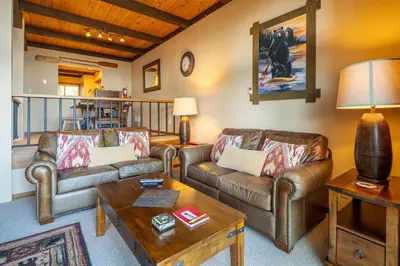 a living room with leather couches and a table at Star Harbor # 4 By Hauserman Rentals in Tahoe City
