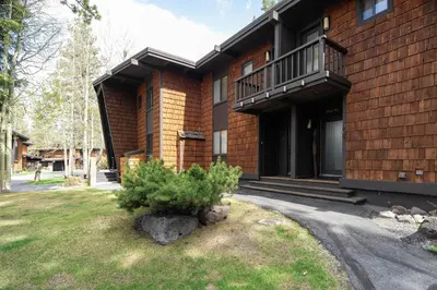 a house with a tree in the front yard at Star Harbor # 4 By Hauserman Rentals in Tahoe City