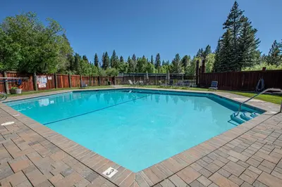 a large swimming pool with blue water in a yard at Star Harbor # 4 By Hauserman Rentals in Tahoe City
