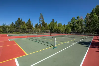 a tennis court with two tennis nets on it at Star Harbor # 4 By Hauserman Rentals in Tahoe City