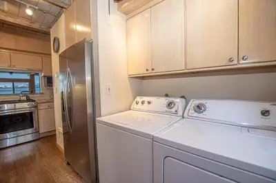 a kitchen with a washer and dryer and a refrigerator at Star Harbor # 8 By Hauserman Rentals in Tahoe City
