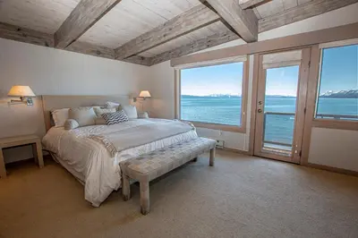 a bedroom with a bed with a view of the ocean at Star Harbor # 8 By Hauserman Rentals in Tahoe City