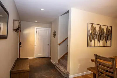 a hallway with a staircase and a stair case at Stephens Retreat By Hauserman Rentals in Carnelian Bay