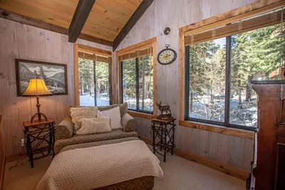 a room with a couch and a clock on the wall at Thunder Lodge By Hauserman Rentals in Homewood