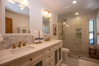 a bathroom with a sink and a toilet and a mirror at Thunder Lodge By Hauserman Rentals in Homewood
