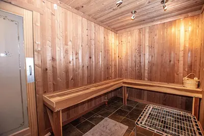 a wooden sauna with a bench in the corner at Thunder Lodge By Hauserman Rentals in Homewood