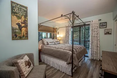 a bedroom with a bed and a chair in a room at Weathertop By Hauserman Rentals in Tahoe City