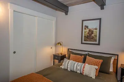 a bedroom with a bed and a painting on the wall at Price Haus By Hauserman Rentals in Tahoe City