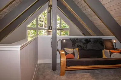 a couch in a room with a window at Price Haus By Hauserman Rentals in Tahoe City