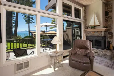 a living room with a chair and a fireplace at Star Harbor # 6 By Hauserman Rentals in Tahoe City