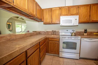 a kitchen with wooden cabinets and a white appliance at St Francis #18 By Hauserman Rentals in Tahoe City