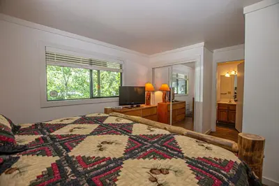 a bedroom with a bed and a window and a television at St Francis #18 By Hauserman Rentals in Tahoe City