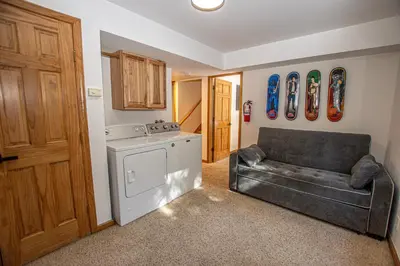 a kitchen with a stove and a couch in a room at Daly's Digs By Hauserman Rentals in Tahoe City