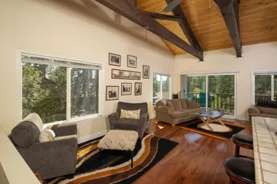 a living room with couches and chairs and windows at Dollar Hill II # 25 By Hauserman Rentals in Tahoe City