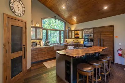a kitchen with a large island with bar stools at Aspen Grove By Hauserman Rentals in Tahoe City