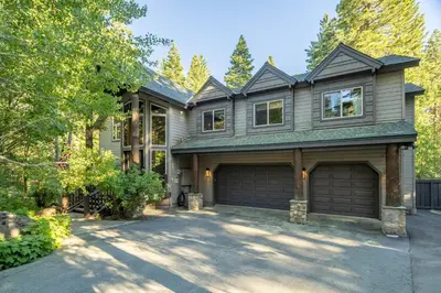 a house with a garage in a driveway at Aspen Grove By Hauserman Rentals in Tahoe City