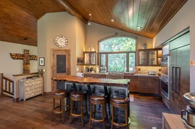 a kitchen with a large island with bar stools at Aspen Grove By Hauserman Rentals in Tahoe City
