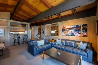 a living room with two leather couches and a table at Rocky Ridge # 04 By Hauserman Rentals in Tahoe City