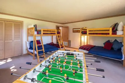 a room with two bunk beds and a pool table at Rocky Ridge # 04 By Hauserman Rentals in Tahoe City
