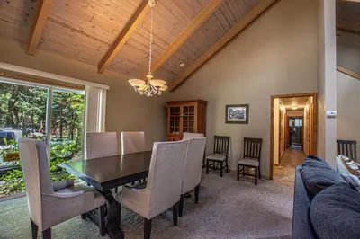a dining room with a table and chairs at Knobcone Cabin by Hauserman Rental Group in Tahoma