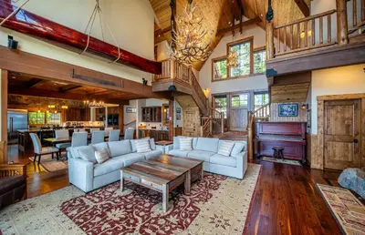 a living room with a couch and a piano at Peaceful Waters By Hauserman Rentals in Tahoma