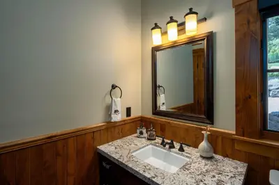 a bathroom with a sink and a mirror at Peaceful Waters By Hauserman Rentals in Tahoma