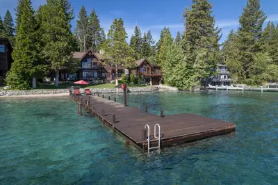 a dock in the water in front of a house at Peaceful Waters By Hauserman Rentals in Tahoma