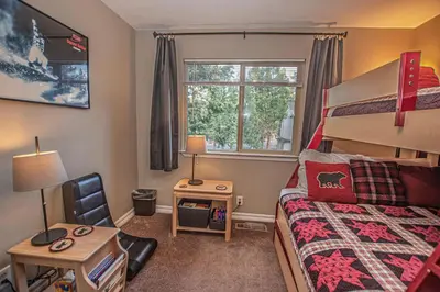 a bedroom with a bed and a desk and a chair at Lake Forest Glen # 117 By Hauserman Rentals in Tahoe City