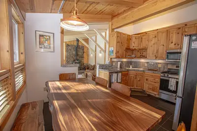 a large kitchen with a wooden table in it at KT22 View By Hauserman Rentals in Olympic Valley