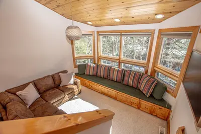 a living room with a couch and some windows at KT22 View By Hauserman Rentals in Olympic Valley
