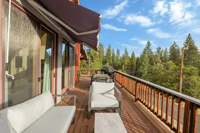 a balcony with a row of chairs on a house at Prasad Retreat - Sunny Home with Deck & Air Hockey home in Arnold