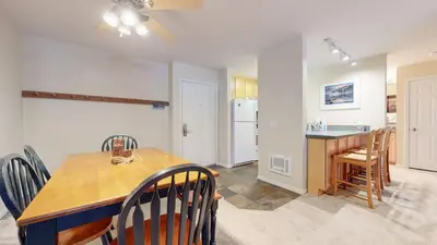 a kitchen and dining room with a table and chairs at Summit #243 condo in Mammoth Lakes