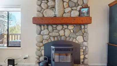a stone fireplace in a living room at Summit #243 condo in Mammoth Lakes