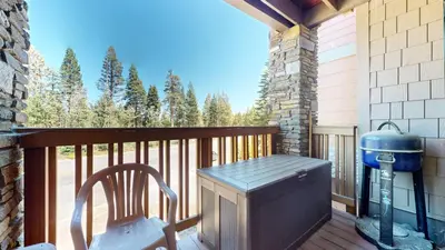 a patio with a heater and a chair on a deck at Summit #243 condo in Mammoth Lakes