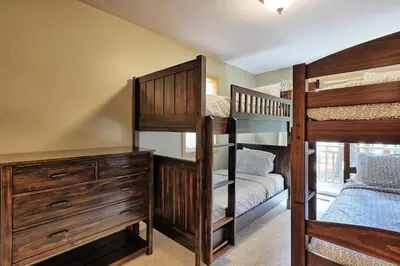 a bedroom with two bunk beds and a dresser at Tahoma Family Home in Tahoma