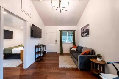 a living room with a couch and a bed at Columbia Cabins Cabin 1 in Sonora