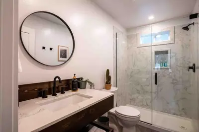 a bathroom with a sink and a toilet and a mirror at Columbia Cabins Cabin 1 in Sonora