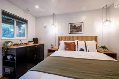 a bedroom with a large bed and a sink at Columbia Cabins Cabin 2 in Sonora