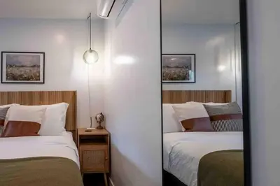 a mirror in a room with two beds in it at Columbia Cabins Cabin 3 in Sonora
