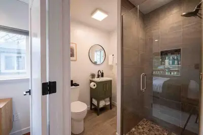 a bathroom with a shower and a toilet and a sink at Columbia Cabins Cabin 4 in Sonora