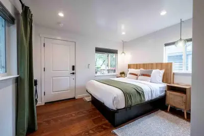 a bedroom with a large bed and a window at Columbia Cabins Cabin 4 in Sonora
