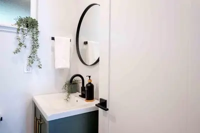 a bathroom with a sink and a mirror at Columbia Cabins Cabin 6 in Sonora