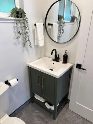 a bathroom with a sink and a mirror at Columbia Cabins Cabin 6 in Sonora