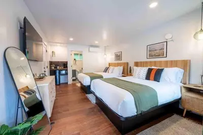a hotel room with two beds and a kitchen at Columbia Cabins Cabin 7 in Sonora